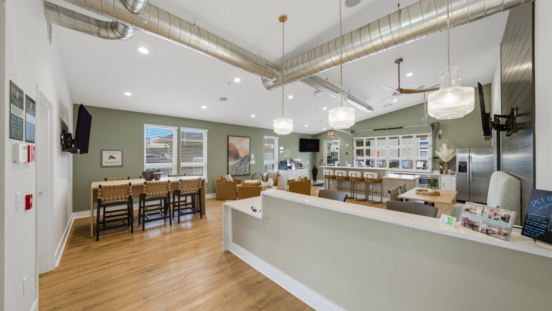 Community clubhouse with reception counter, flexible seating and onsite management at Authentix Town Creek.