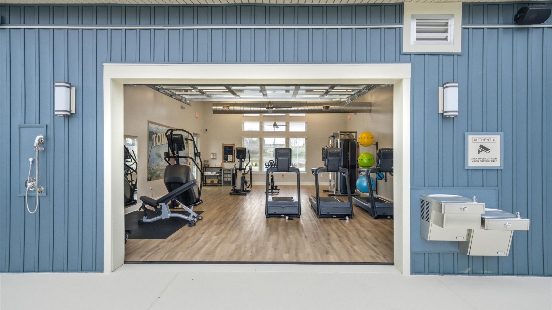 24/7 fitness center with treadmills, strength machine, and medicine balls at Authentix Town Creek.