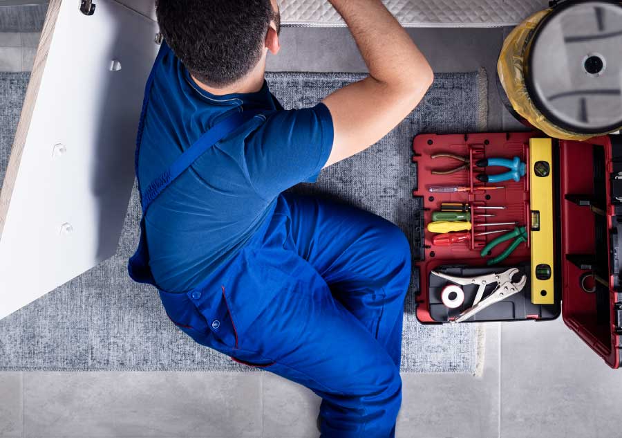 maintenance_worker_under_sink