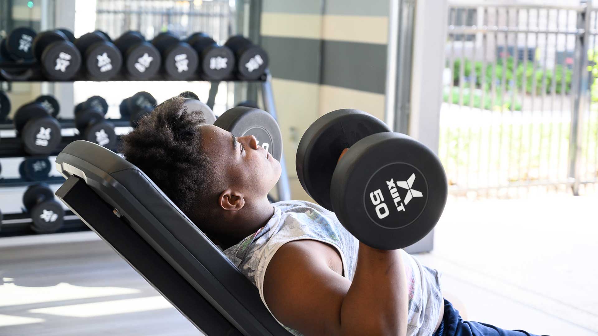 Lifting free weights in fitness center